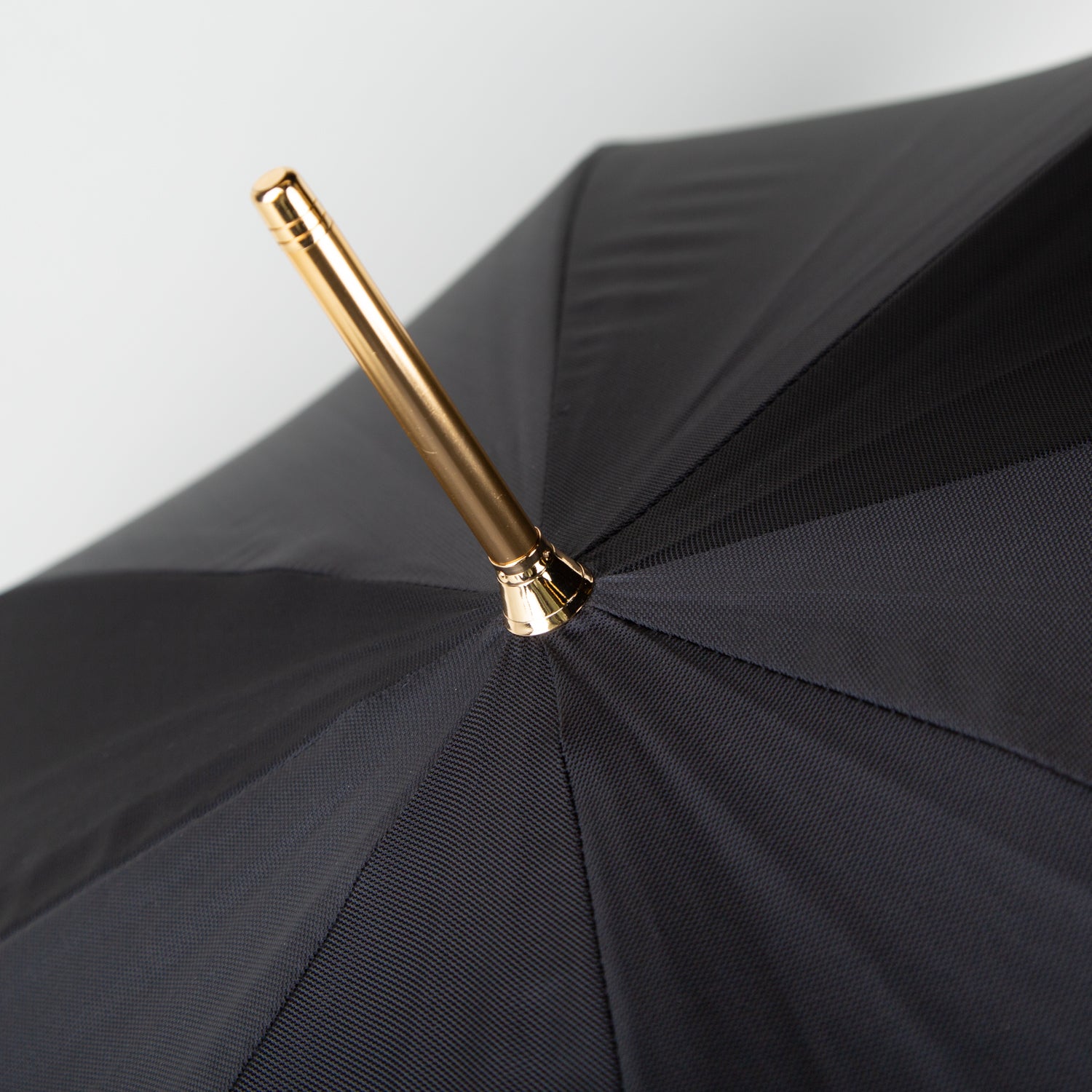 golden horse umbrella with a black canopy